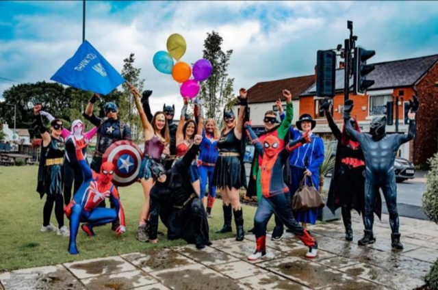 team of superheroes celebrating